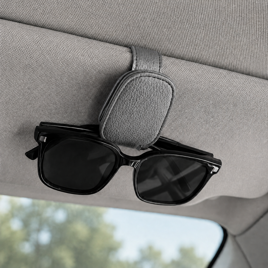 Grey car sun visor glasses holder with sunglasses