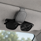 Grey car sun visor glasses holder with sunglasses